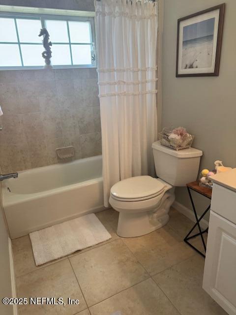 full bath with vanity, tile patterned flooring, toilet, and shower / tub combo