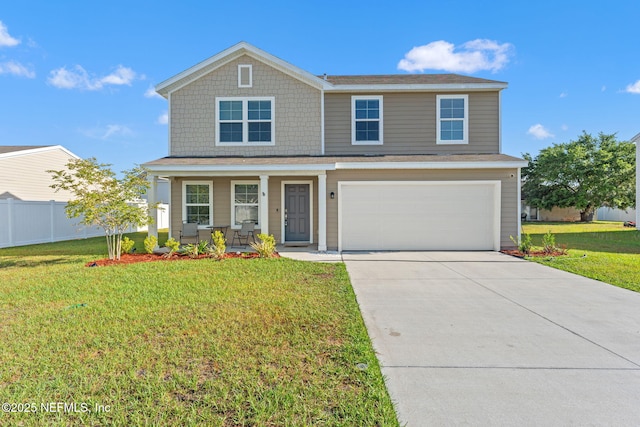 traditional-style house featuring covered porch, fence, concrete driveway, and a front yard