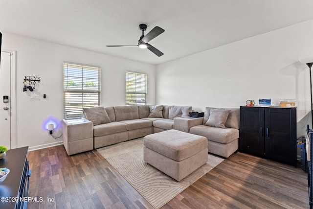 living area featuring dark wood-style flooring, ceiling fan, and baseboards