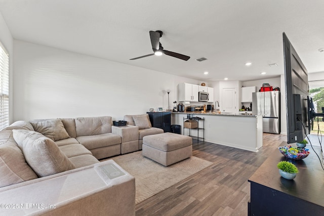 living area featuring visible vents, recessed lighting, ceiling fan, and wood finished floors