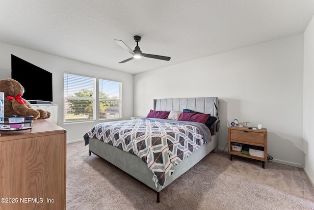 bedroom featuring baseboards, a ceiling fan, and light colored carpet