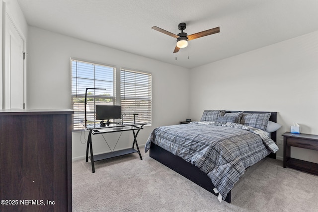 bedroom featuring baseboards and light carpet