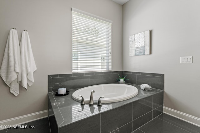 full bath with baseboards, a wealth of natural light, and a bath