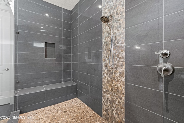 full bath with a tile shower