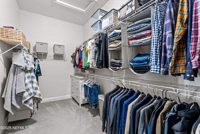 walk in closet featuring carpet floors and attic access
