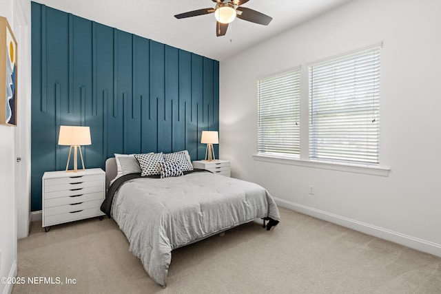 carpeted bedroom with baseboards and ceiling fan