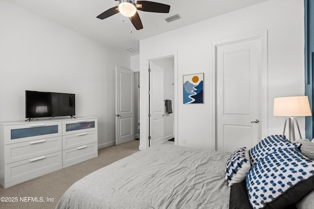 bedroom featuring light colored carpet, a ceiling fan, and visible vents