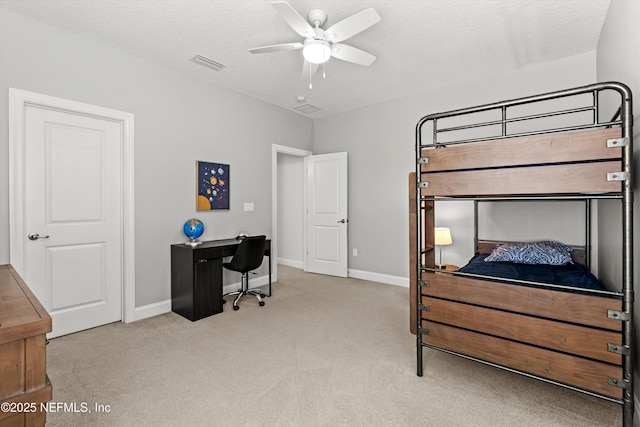 carpeted bedroom with a ceiling fan, baseboards, visible vents, and a textured ceiling