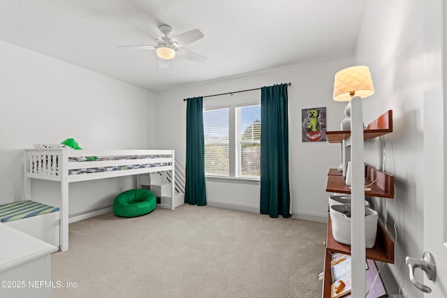 carpeted bedroom with baseboards and ceiling fan