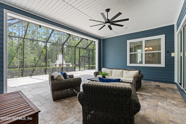 view of patio with an outdoor living space, ceiling fan, and a lanai