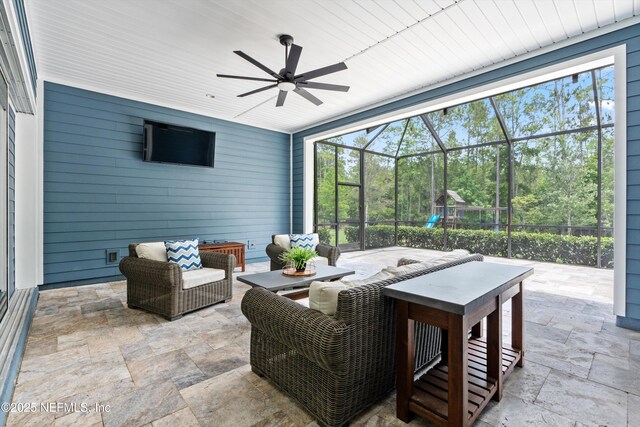 view of patio / terrace with an outdoor living space, a ceiling fan, and a lanai