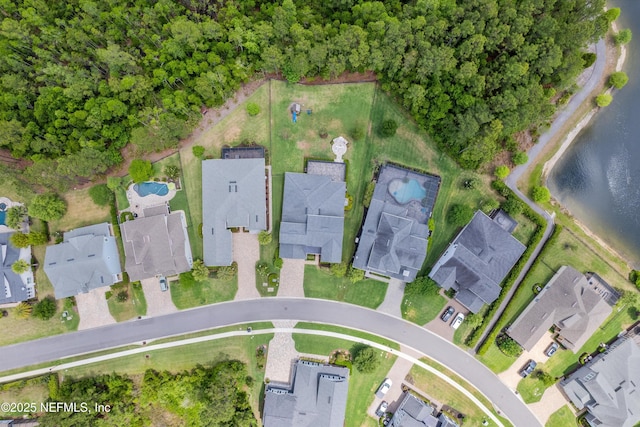 birds eye view of property featuring a water view and a residential view