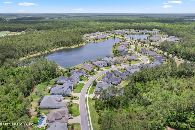 birds eye view of property featuring a water view, a residential view, and a wooded view