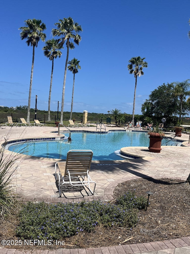community pool with a patio area