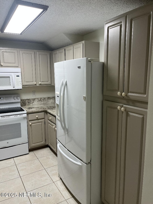 kitchen with white appliances, light tile patterned floors, gray cabinets, a textured ceiling, and lofted ceiling