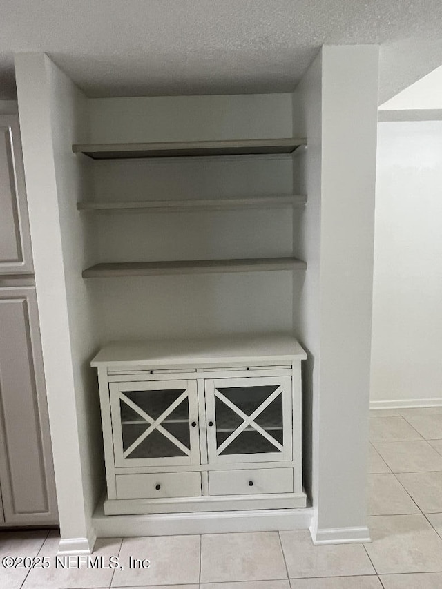 detailed view of a textured ceiling and baseboards