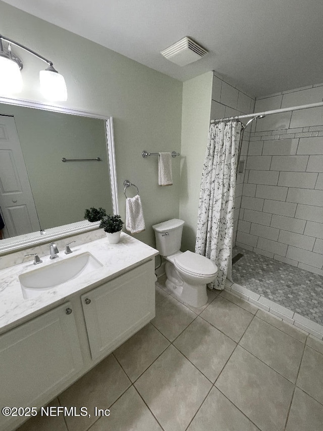 4000 Grande Vista Blvd Unit 15-102, Saint Augustine, FL 32084 - bathroom featuring vanity, toilet, a tile shower, and tile patterned flooring