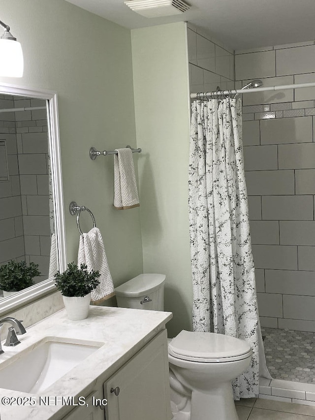 4000 Grande Vista Blvd Unit 15-102, Saint Augustine, FL 32084 - bathroom with vanity, toilet, a shower stall, and tile patterned flooring