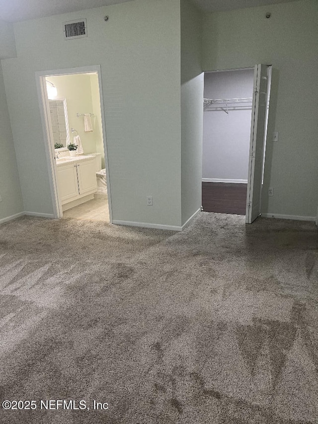 4000 Grande Vista Blvd Unit 15-102, Saint Augustine, FL 32084 - unfurnished bedroom featuring carpet, baseboards, and ensuite bathroom