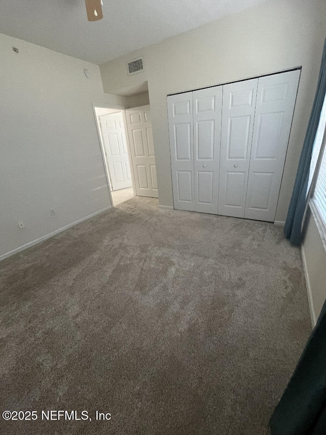 4000 Grande Vista Blvd Unit 15-102, Saint Augustine, FL 32084 - unfurnished bedroom featuring carpet, a closet, and baseboards