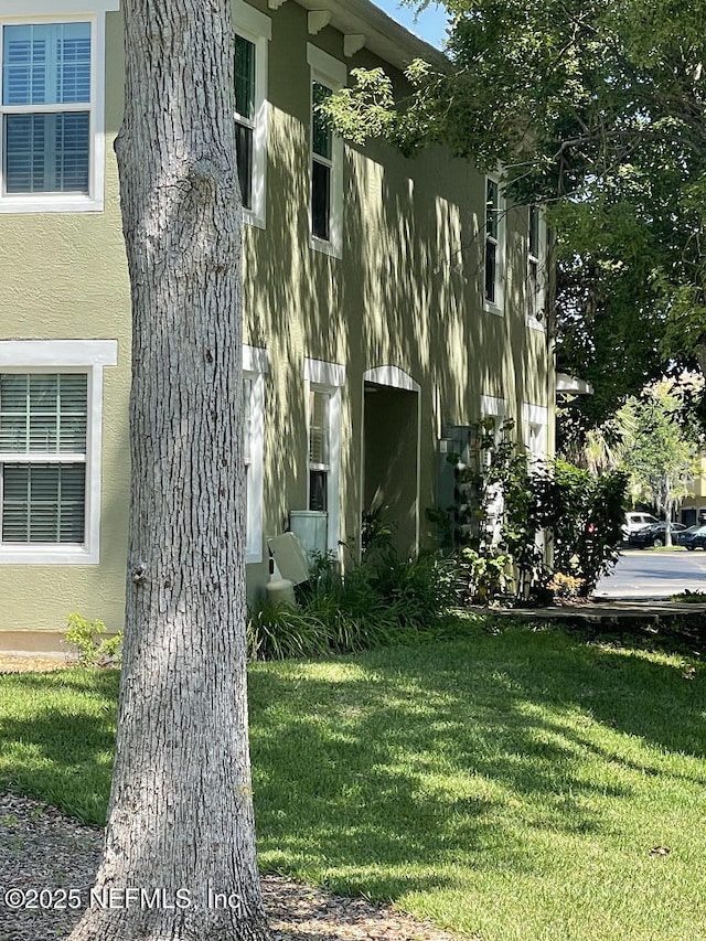 4000 Grande Vista Blvd Unit 15-102, Saint Augustine, FL 32084 - view of side of home with a yard and stucco siding