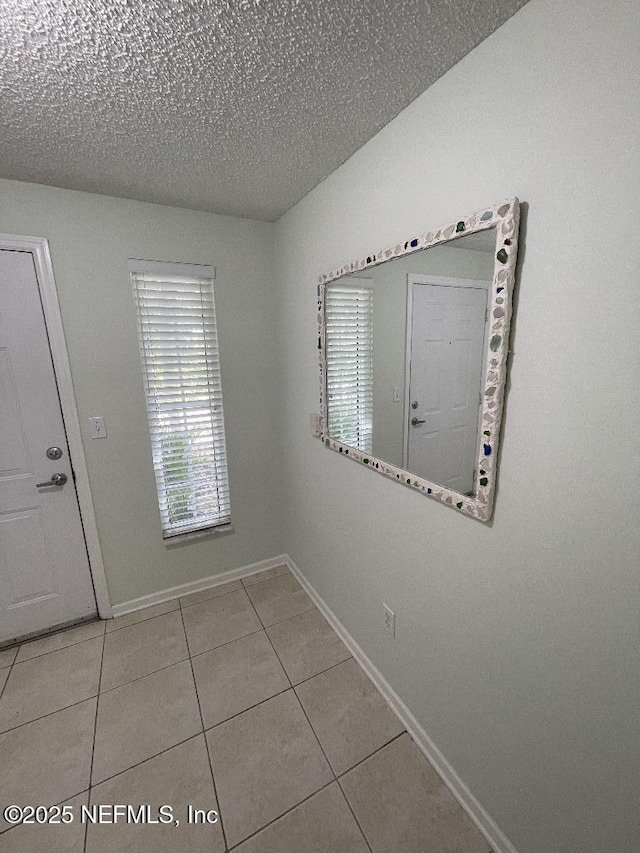 4000 Grande Vista Blvd Unit 15-102, Saint Augustine, FL 32084 - tiled empty room with baseboards and a textured ceiling