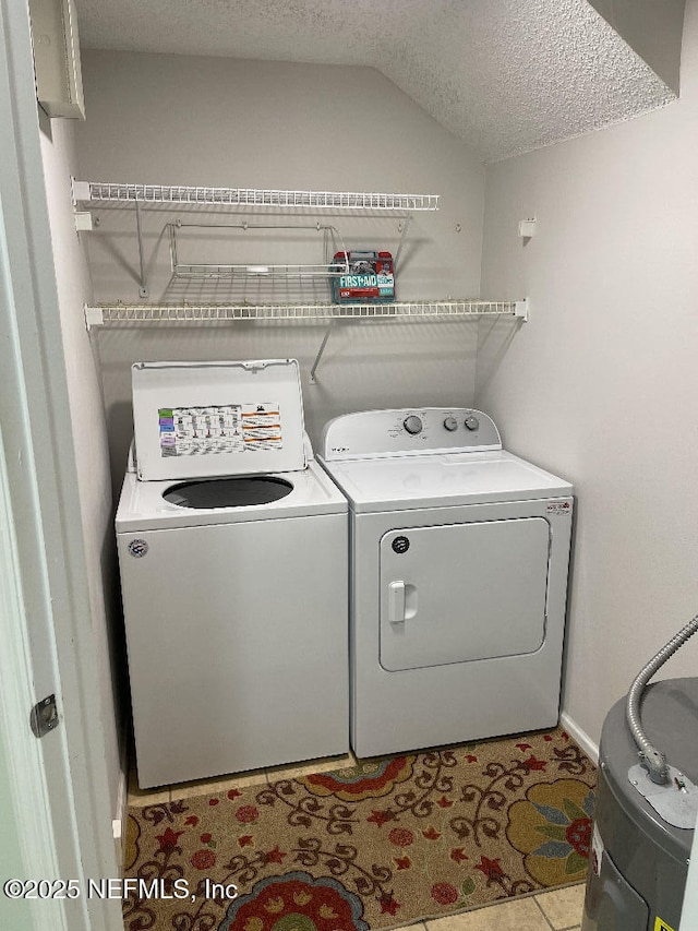 4000 Grande Vista Blvd Unit 15-102, Saint Augustine, FL 32084 - laundry area featuring separate washer and dryer, a textured ceiling, and baseboards