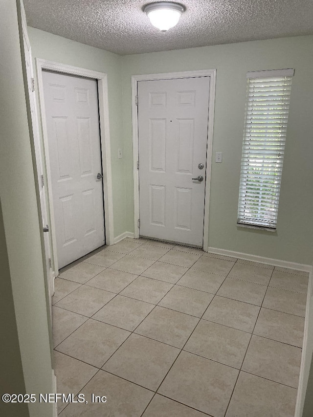 4000 Grande Vista Blvd Unit 15-102, Saint Augustine, FL 32084 - foyer entrance featuring light tile patterned floors, a textured ceiling, and baseboards