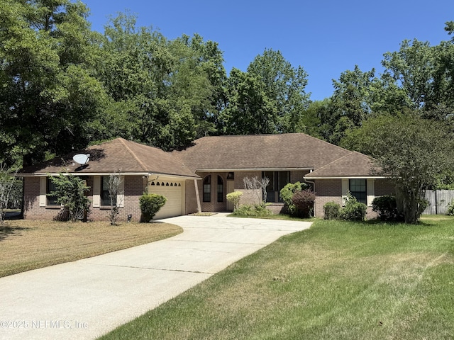 1800 Norway Dr, Fleming Island, FL 32003 - single story home with brick siding, an attached garage, driveway, and a front yard