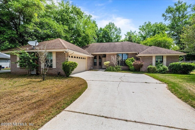 1800 Norway Dr, Fleming Island, FL 32003 - ranch-style house with brick siding, a garage, driveway, and a front yard