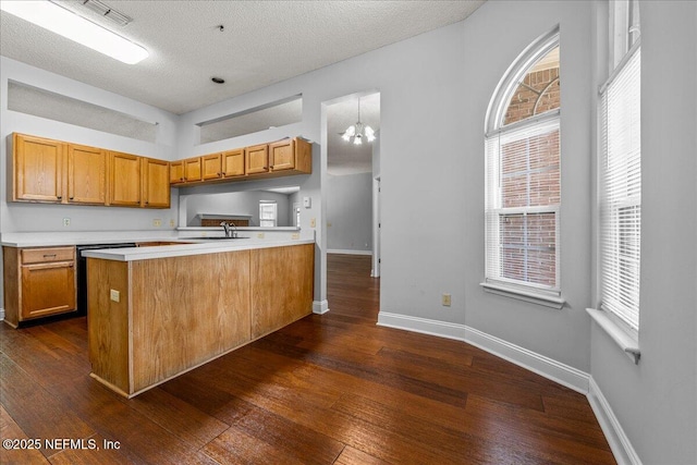 1800 Norway Dr, Fleming Island, FL 32003 - kitchen with light countertops, dark wood finished floors, baseboards, a chandelier, and a textured ceiling