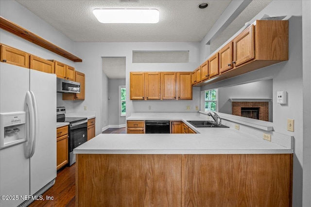 1800 Norway Dr, Fleming Island, FL 32003 - kitchen featuring stainless steel appliances, a sink, dark wood finished floors, light countertops, and a textured ceiling