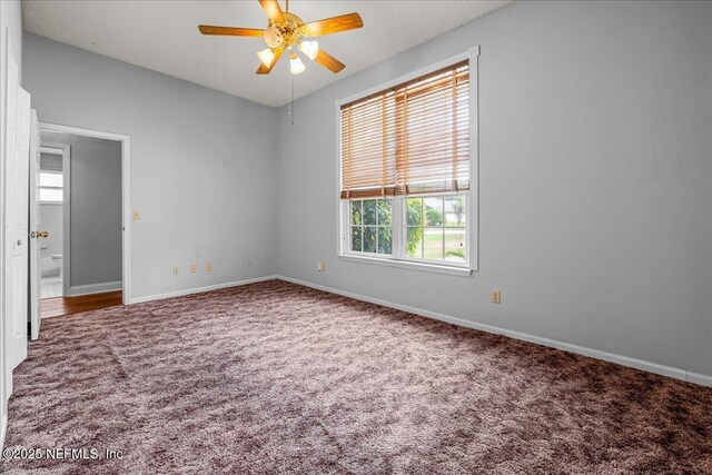 1800 Norway Dr, Fleming Island, FL 32003 - unfurnished bedroom with carpet flooring, baseboards, and ceiling fan