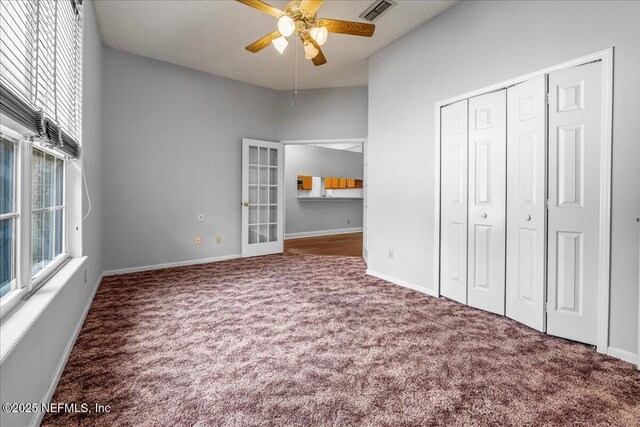 1800 Norway Dr, Fleming Island, FL 32003 - unfurnished bedroom with carpet, a closet, baseboards, and ceiling fan