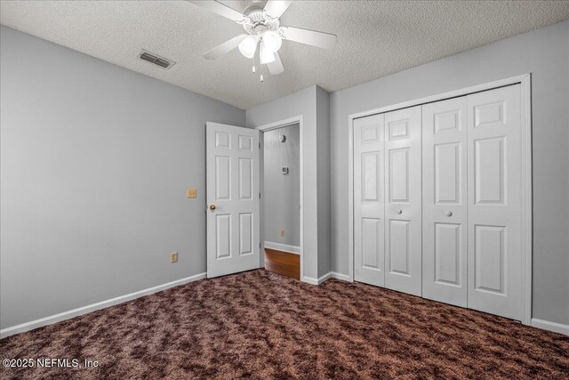 1800 Norway Dr, Fleming Island, FL 32003 - unfurnished bedroom with carpet flooring, a textured ceiling, baseboards, a closet, and ceiling fan