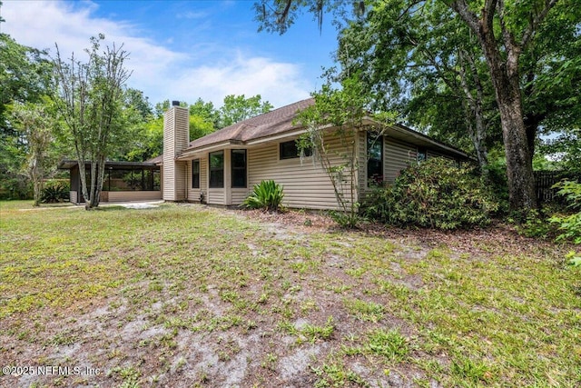 1800 Norway Dr, Fleming Island, FL 32003 - rear view of property featuring a chimney and a lawn