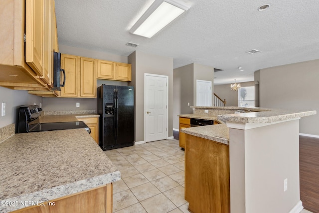 kitchen with light countertops, a notable chandelier, light brown cabinetry, and black appliances