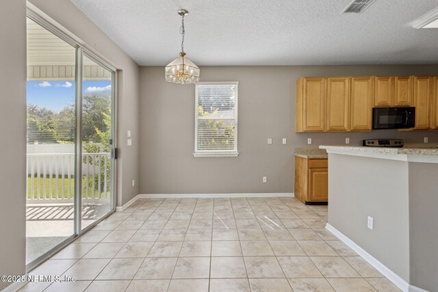kitchen with visible vents, black microwave, light countertops, electric stove, and a notable chandelier