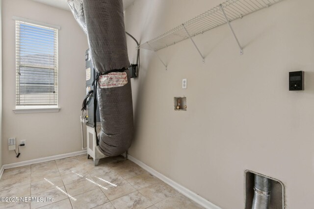 laundry room featuring baseboards, laundry area, and hookup for a washing machine
