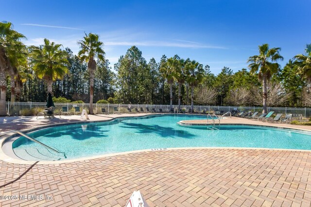 pool featuring a patio and fence