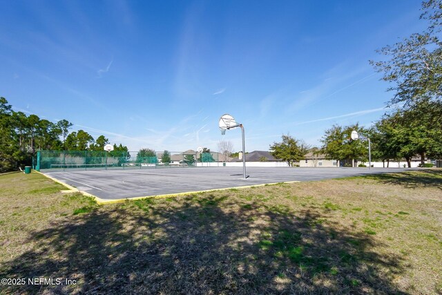 exterior space featuring fence, community basketball court, and a tennis court
