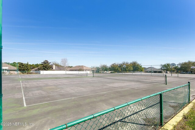 view of tennis court with fence