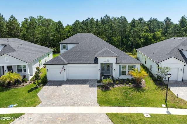 535 Archstone Way, Saint Augustine, FL 32092 - view of front of home featuring a garage, driveway, a front yard, and a shingled roof