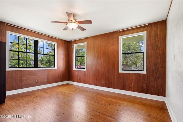 5104 Hollycrest Dr, Jacksonville, FL 32205 - unfurnished room with plenty of natural light, a ceiling fan, baseboards, and hardwood / wood-style floors