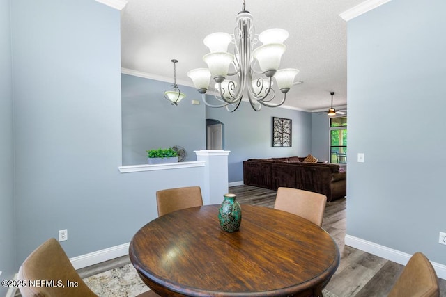 32238 Settlers Ridge Dr, Bryceville, FL 32009 - dining area featuring ornamental molding, wood finished floors, baseboards, a chandelier, and ceiling fan