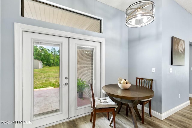 32238 Settlers Ridge Dr, Bryceville, FL 32009 - dining room featuring french doors, wood finished floors, baseboards, and a chandelier
