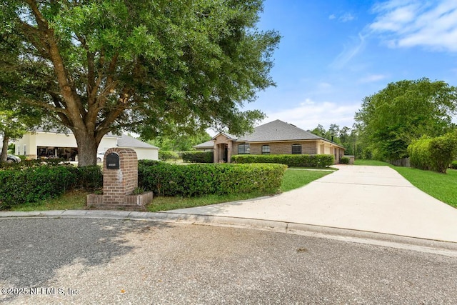 32238 Settlers Ridge Dr, Bryceville, FL 32009 - view of front facade with concrete driveway and a front yard