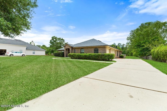 32238 Settlers Ridge Dr, Bryceville, FL 32009 - ranch-style house featuring concrete driveway, a front lawn, a garage, and brick siding
