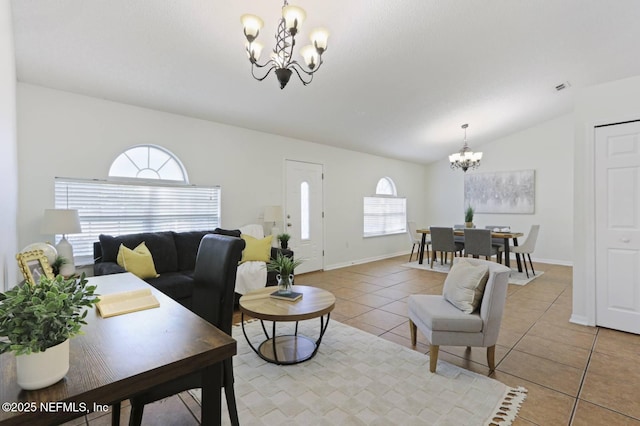 12394 Glenn Hollow Dr, Jacksonville, FL 32226 - living room with a chandelier, light tile patterned floors, lofted ceiling, and baseboards