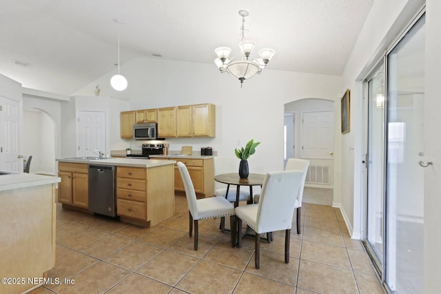 12394 Glenn Hollow Dr, Jacksonville, FL 32226 - dining area with arched walkways, light tile patterned floors, a chandelier, and high vaulted ceiling